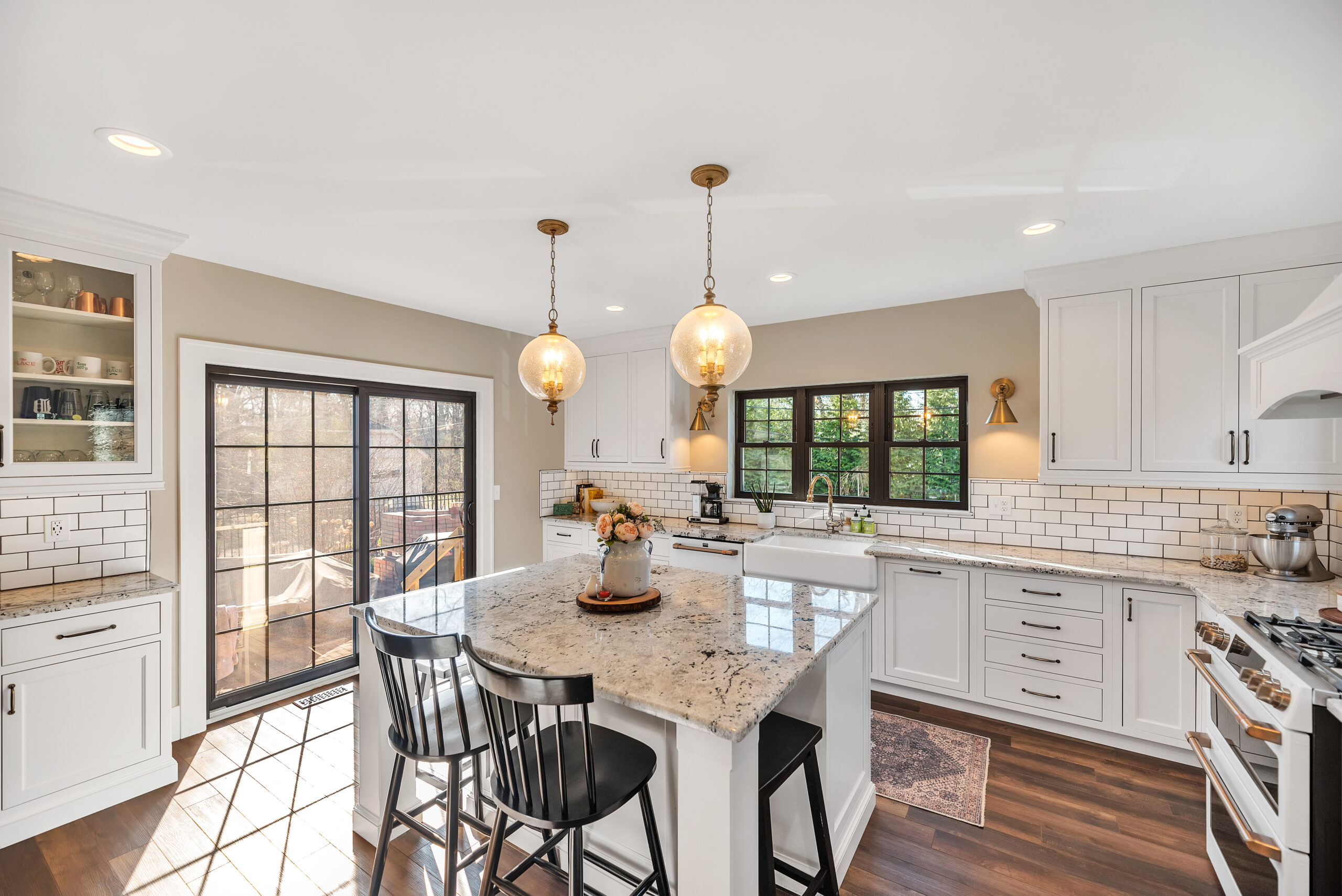 Bright modern kitchen with island and pendant lights.