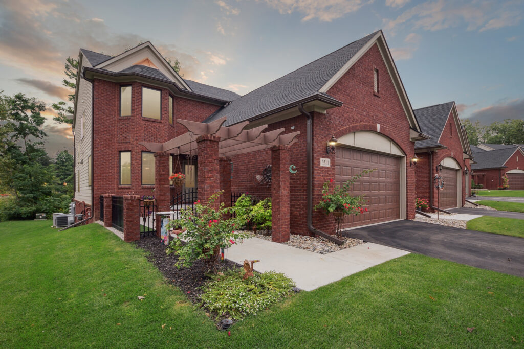 Modern brick house with a well-kept front lawn and attached garage.