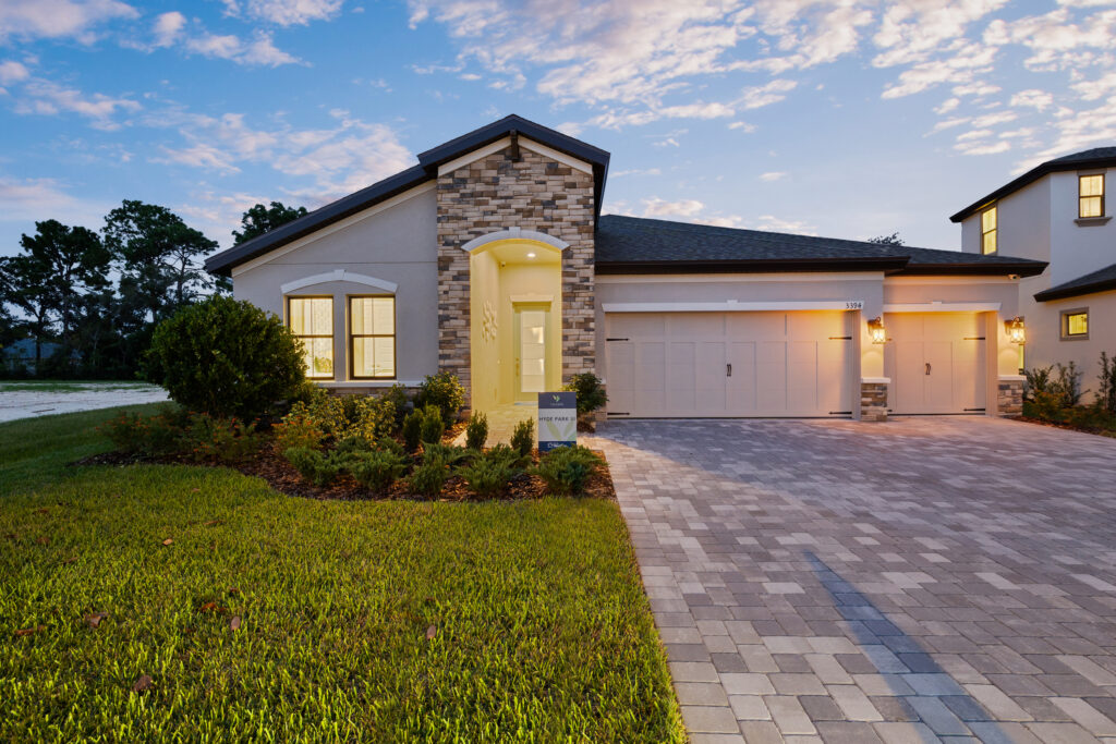 Modern single-story house with stone accents and a well-lit entrance.