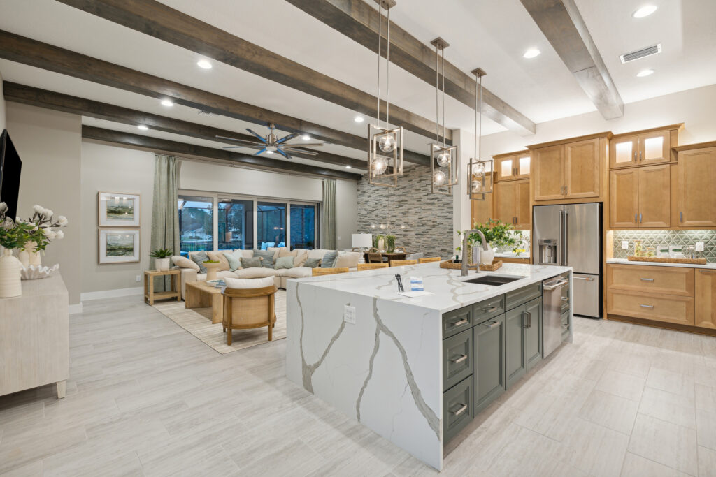 Modern kitchen with marble island and wooden accents.