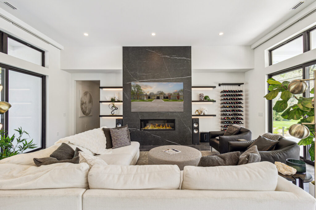 Modern living room with a cozy fireplace and neutral-toned furniture.