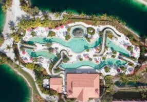 Aerial view of a luxurious residential pool with winding water slides.